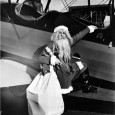 Merry Christmas Everyone Santa Claus climbing into a Stearman airplane at hangar at Wichita Municipal Airport in city’s southeast section, 1929 by Edgar B. Smith.