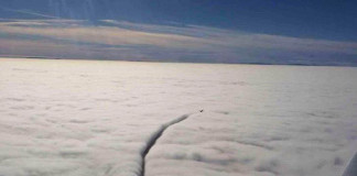 An airplane slicing through the clouds