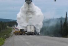 A fire-fighting Canadair puts out a truck on fire in the North of Canada
