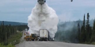 A fire-fighting Canadair puts out a truck on fire in the North of Canada