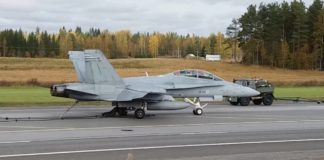 F/A-18D Hornet uses arresting gear to land on a road base