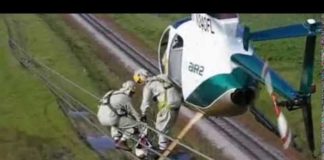 Helicopter Transfering Linemen to Wire