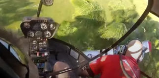 Kid Gets RC Plane Stuck In Tree, Guys In Helicopter Come To The Rescue Fishing out a P-51 Mustang model airplane with a Robinson R-22