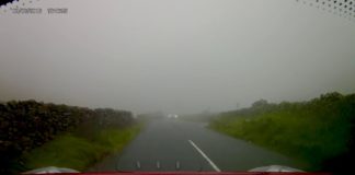 Helicopter surprises a driver by flying super close to a mountain pass in dense fog