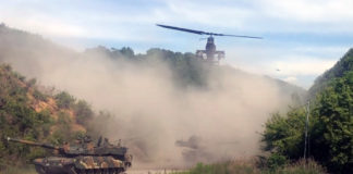 AH-1S Cobra Flying Over a Column of K2 Black Panthers