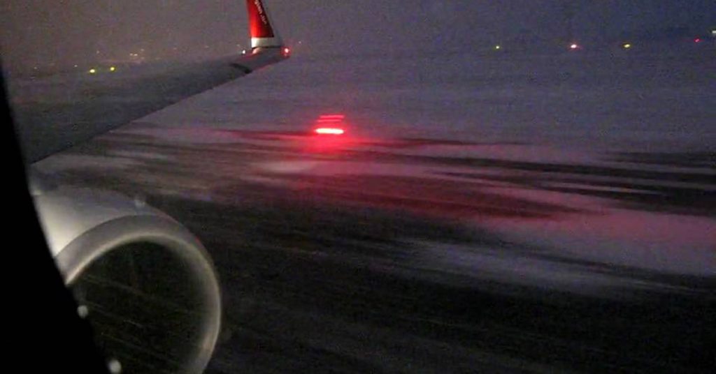 Boeing 737 Airplane Taking Off In Snowstorm