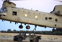 Boeing CH-47 Chinook Helicopter Lifting Humvee Boeing CH-47 Chinook Helicopter Lifting Humvee