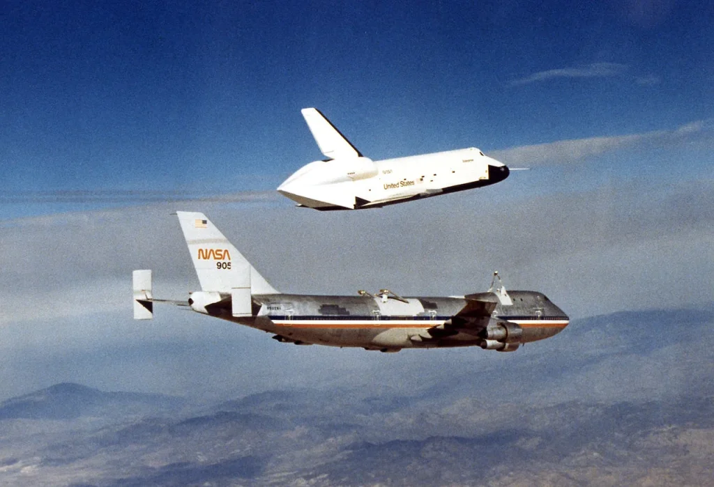The Space Shuttle Enterprise (OV-101) flying free after being released from its NASA 747 Shuttle Carrier Aircraft, showcasing the iconic reusable spacecraft that revolutionized space travel.